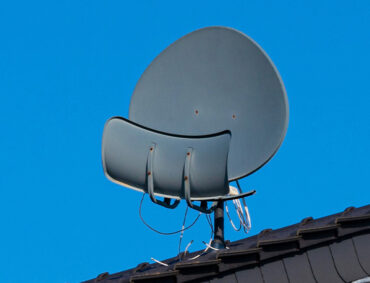 three-satellite-dishes-roof-tiled-house-blue-sky